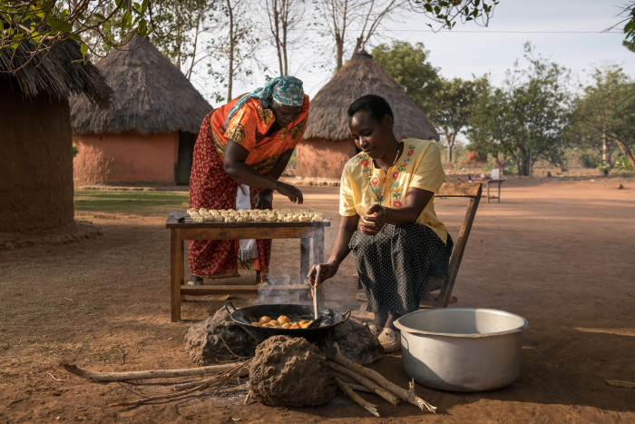 Women cooking over a fire pit
