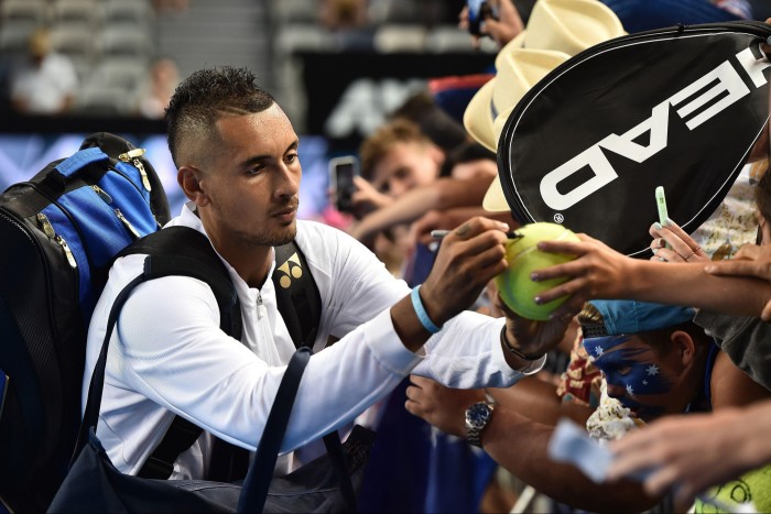 Nick Kyrgios signs autographs for a crowd of fans