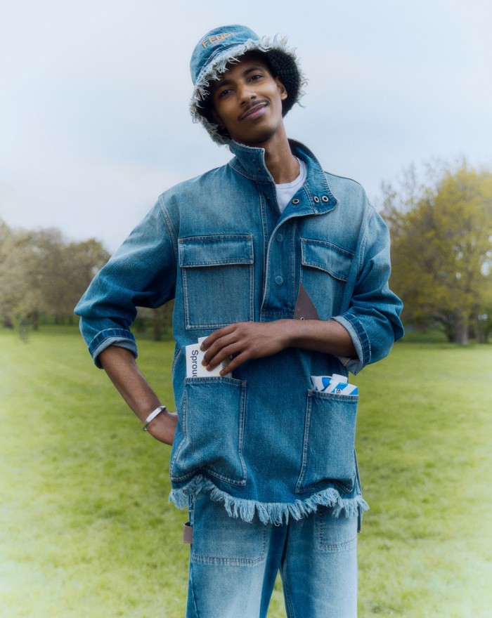 Mohamed wears Fendi cotton denim jacket, £1,400, matching trousers, £1,100, and matching hat, £580. Sunspel supima cotton T-shirt, £85. Bunney silver bangle, £490