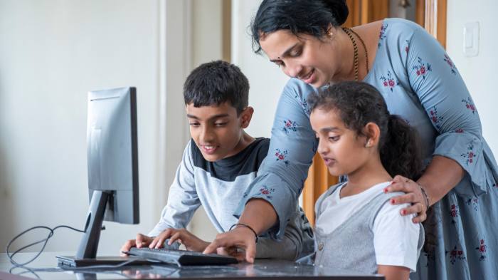 Indian mother teaching her kids with pc at home