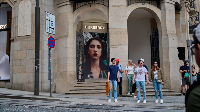 Tourists stand in front of Burberry store in Avenida dos Aliados, Porto 