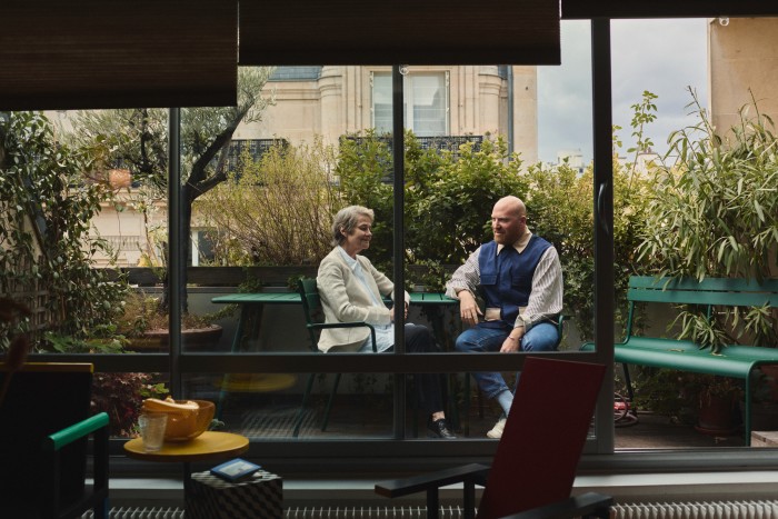Lasry with Rampling on his apartment balcony