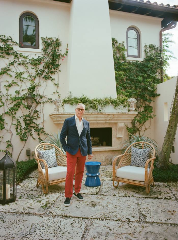 Hilfiger stands in a courtyard at home