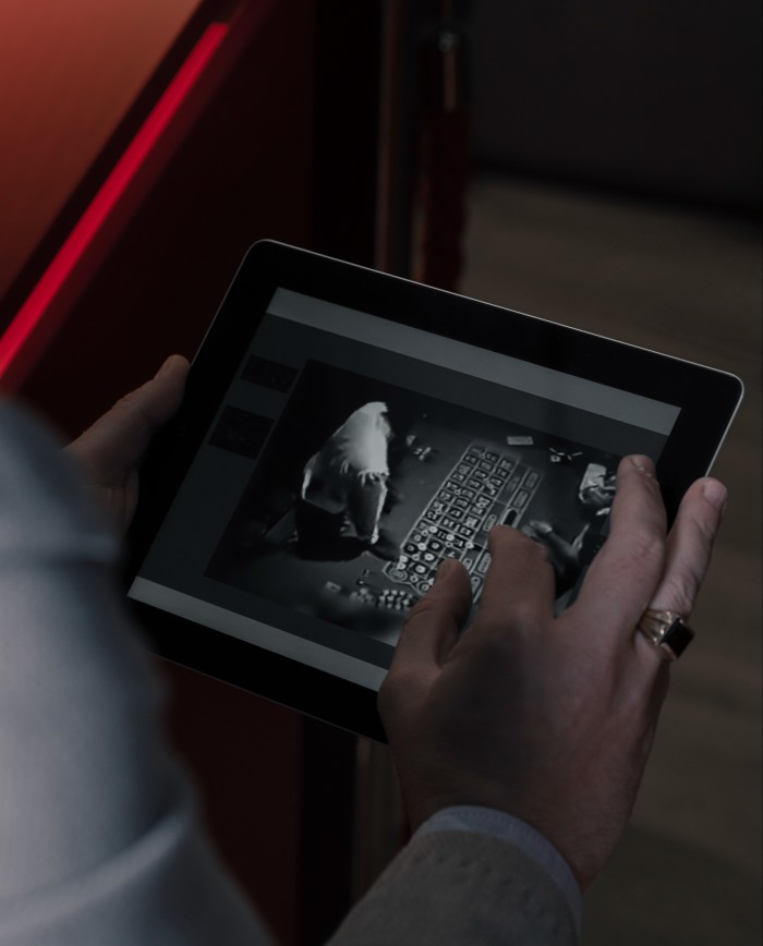A person checking security footage on a tablet