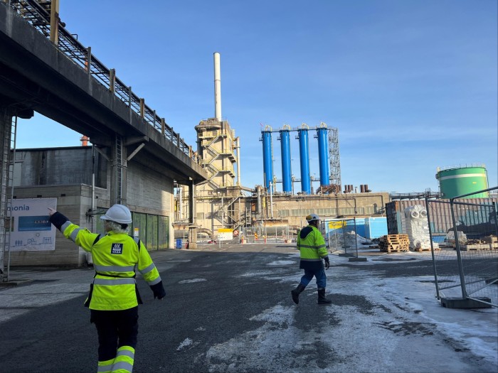 Workers in high-visibility jackets walk through Yara’s Porsgrunn plant