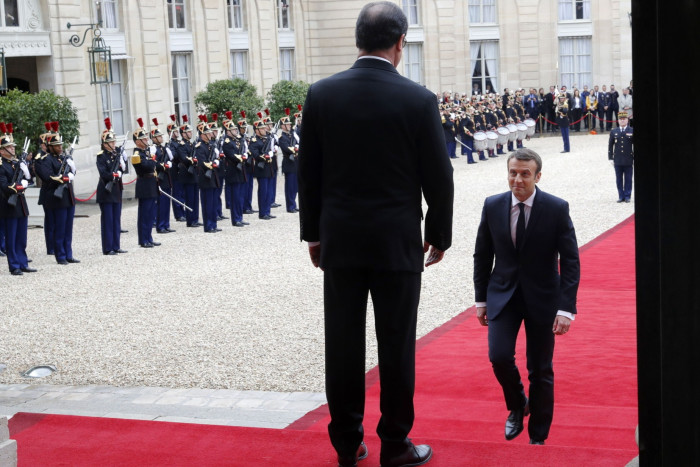 Emmanuel Macron walks towards his predecessor, Francois Hollande 