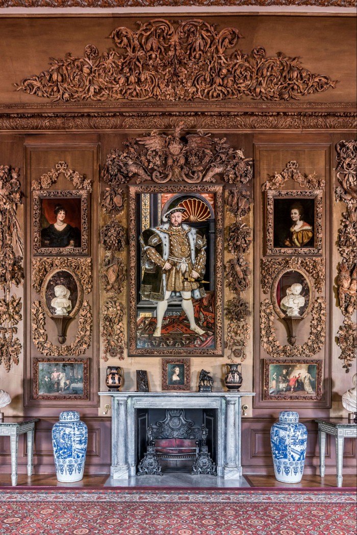 An imperious Henry VIII, in a portrait from the studio of Hans Holbein, looks down on the Carved Room
