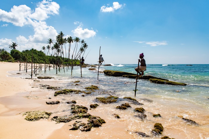Stilt fishing off the beach at Mirissa, southern Sri Lanka