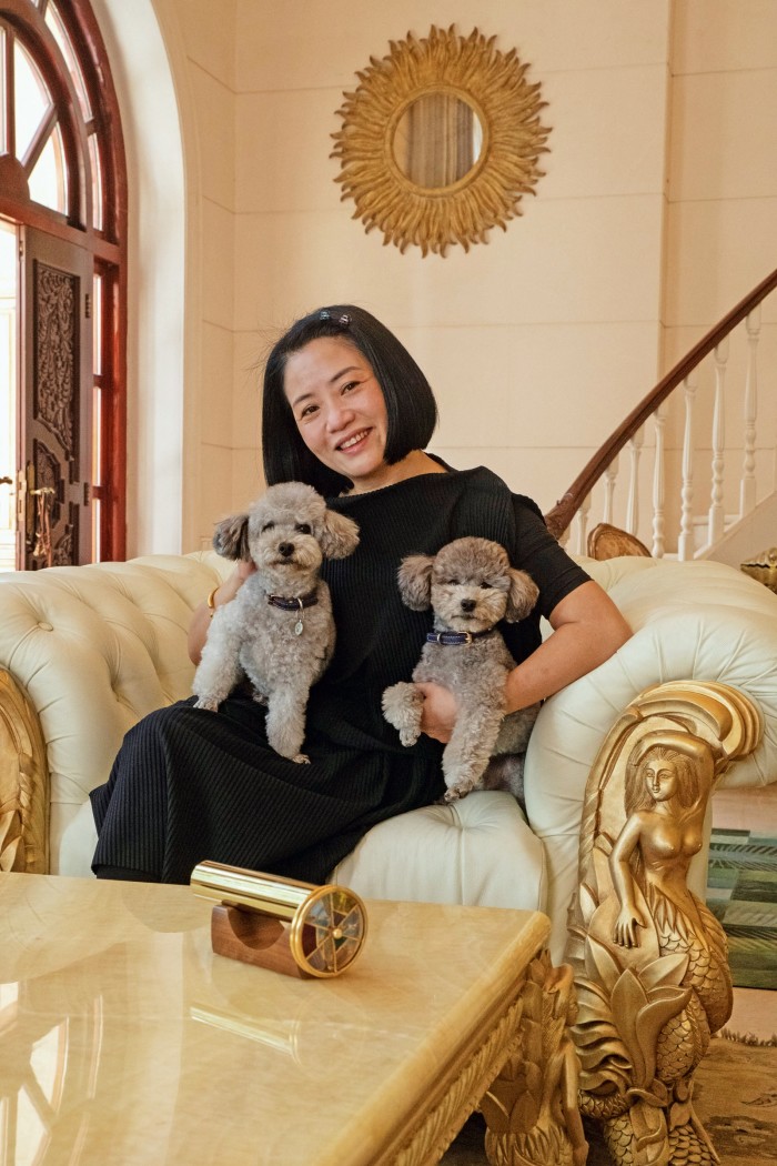 Fashion designer Guo Pei at home in Beijing with her poodles Nuomi (“Sticky Rice”, near right) and Zhuanzhuan
