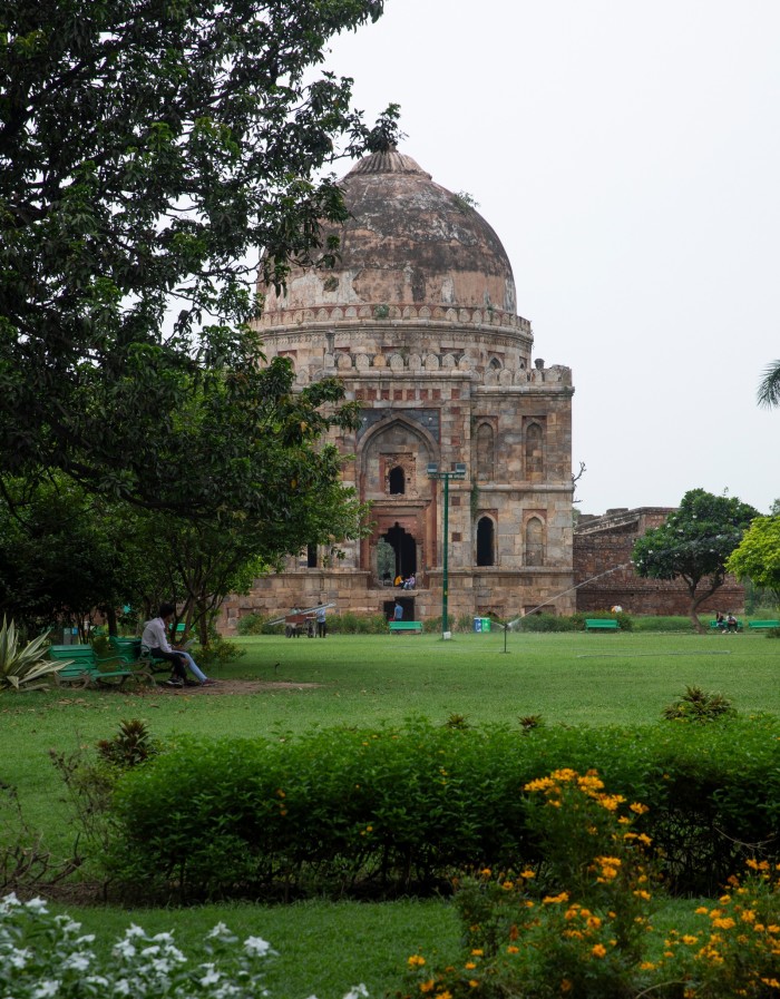 Locals and tourists relax in front of Shisha Gumbad in the Lodhi Gardens