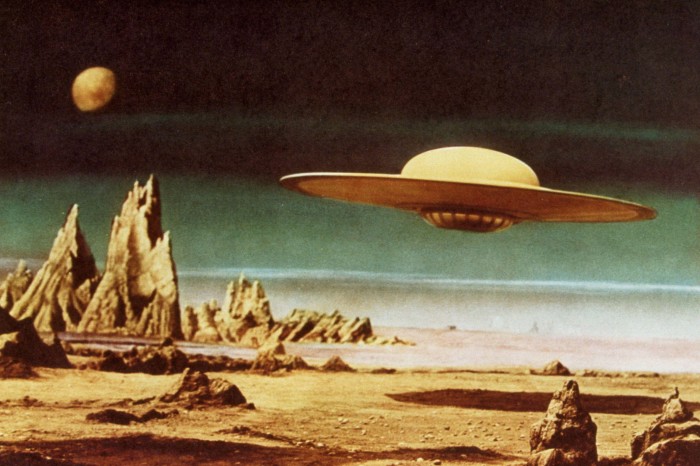 A flying saucer hovers above a desolate alien world in a still from ‘Forbidden Planet’