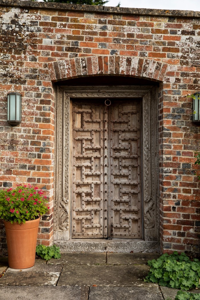The antique Indian teak doors from Cape Town at the entrance to his pool house
