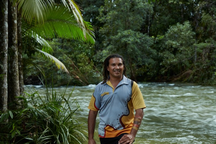 Juan Walker, a Kuku Yalanji guide from Walkabout Tours on the banks of the river near the Lodge