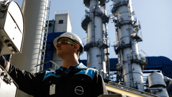 An employee checks temperatures at a hot oil pump at the Covestro AG chemical park in Dormagen, Germany