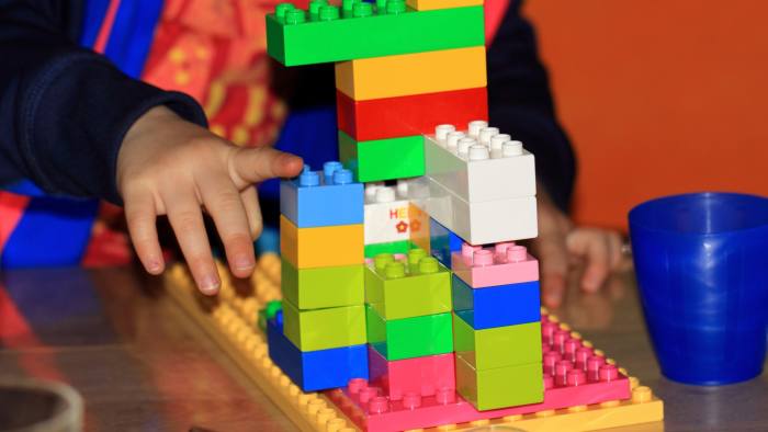 A child plays with plastic bricks 