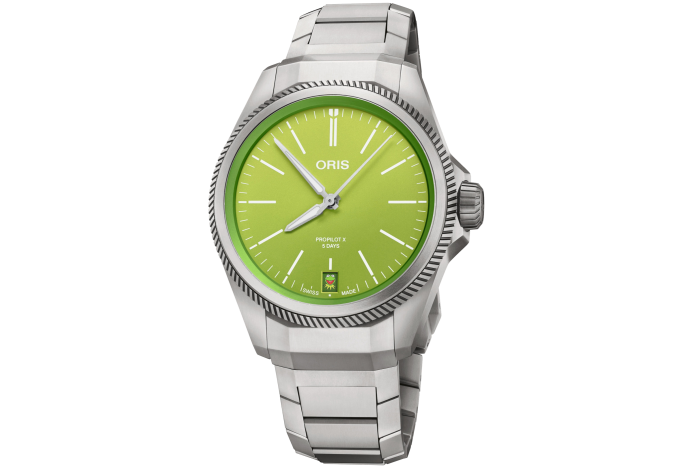 A timepiece with a silver bracelet and green-coloured face