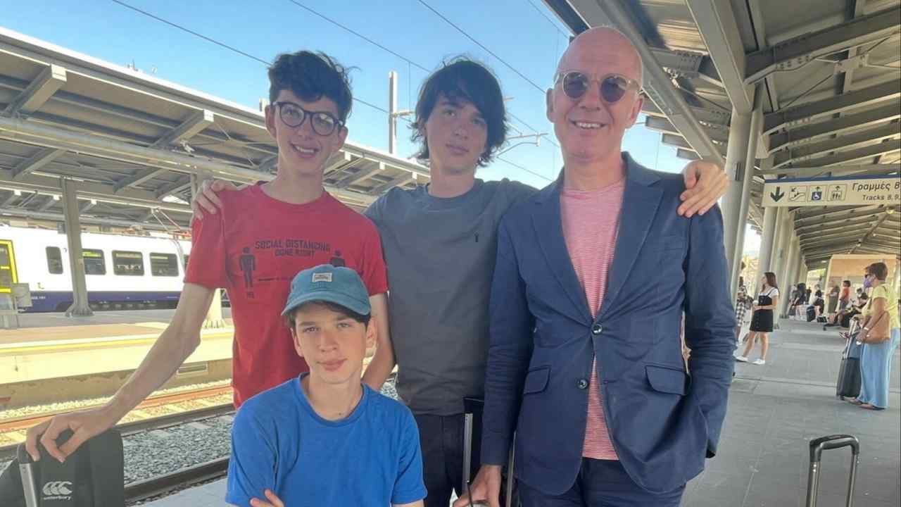 Four males on a train platform