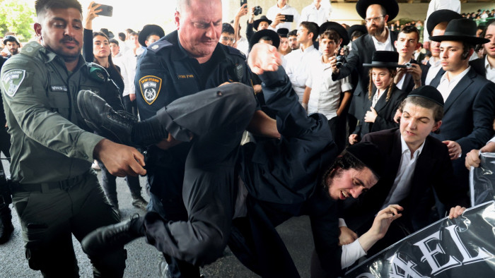 Israeli police remove a protester as they disperse ultraorthodox Jews blocking a road during a demonstration in Bnei Brak last week against moves to lift their exemption from military service