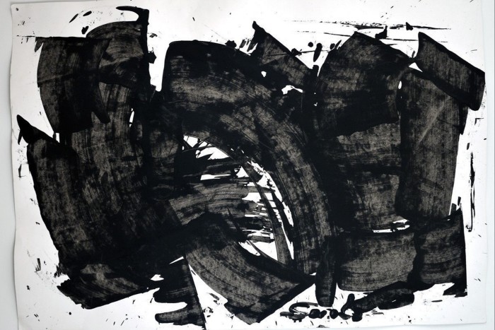 Abstract painting of thick black strokes on a white background