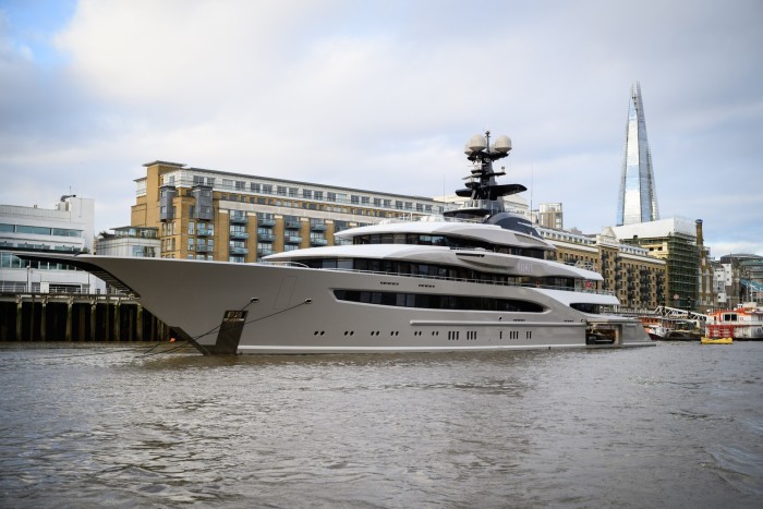 A superyacht is moored on the River Thames in London, with the Shard in the background