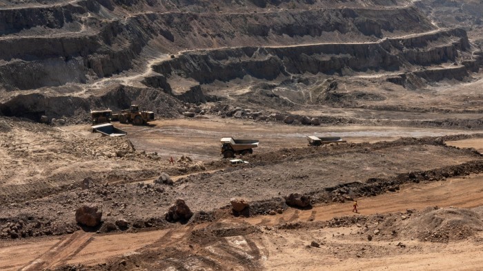 Trucks haul away ore from a pit in Tenke Fungurume Mine, one of the largest copper and cobalt mines in the world, owned by Chinese company CMOC,