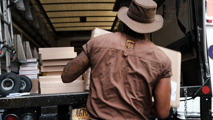 a UPS worker in Manhattan delivers packages on his daily rounds