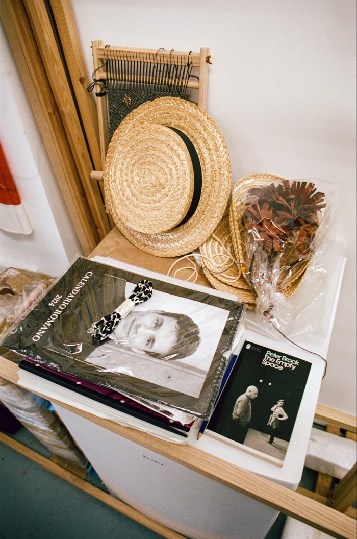 Books and hats in her studio
