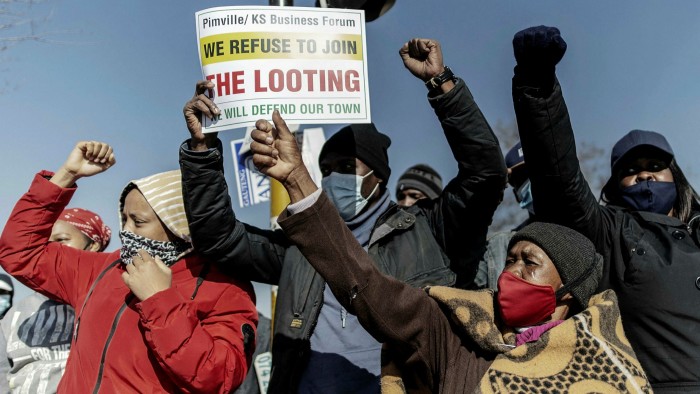 Residents protest against looting and violence in Soweto on Wednesday