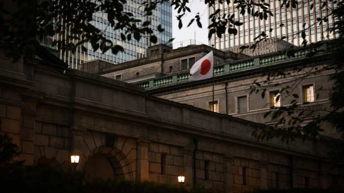 A Japanese national flag flies outside the Bank of Japan in Tokyo
