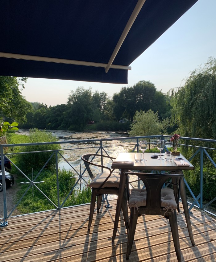 An idyllic restaurant by a river 