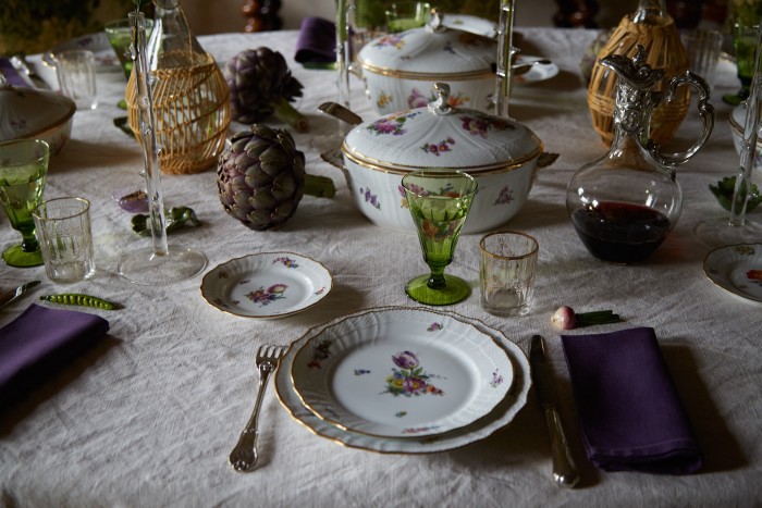 The dining table laid with vintage glasses and a Royal Copenhagen dinner service