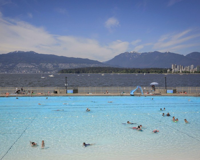 Bathers in Kitsilano swimming pool, which looks over the bay, Vancouver and North Shore mountains 