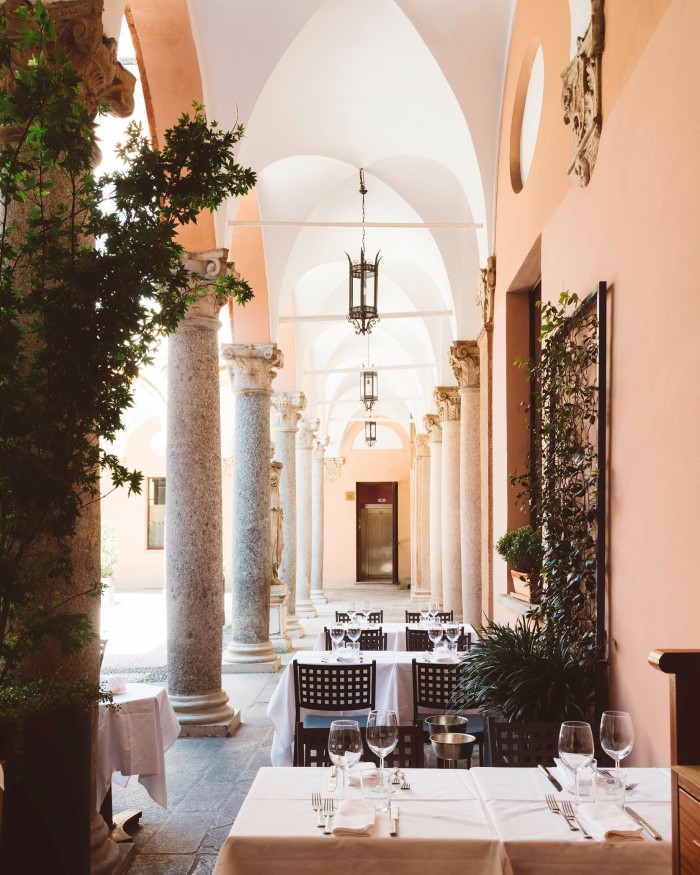 Dal Bolognese’s courtyard, with tables beneath a vaulted ceiling supported by granite columns