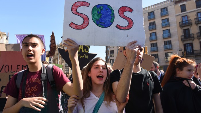 young protesters holding up an SOS sign