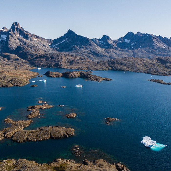 Aerial view of a bay in Greenland surrounded by mountains