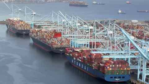 Shipping containers are unloaded from ships at a container terminal