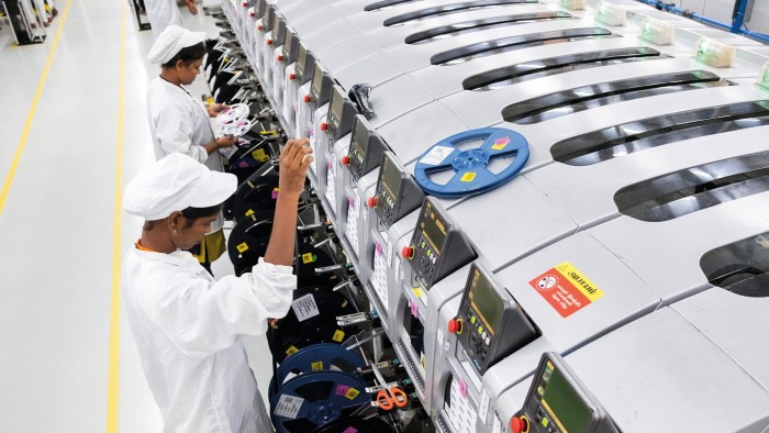 Employees working in a mobile phone factory