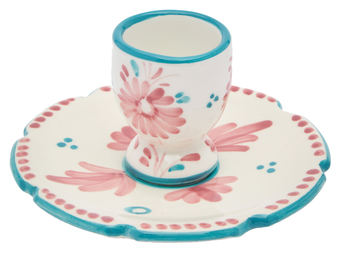 Floral-themed egg cup sitting on a plate