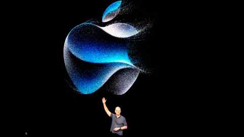Tim Cook waves while on stage