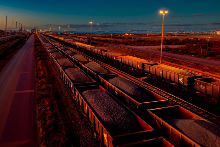 Rail cars full of iron ore at  Saldanha Bay Port at dusk in South Africa
