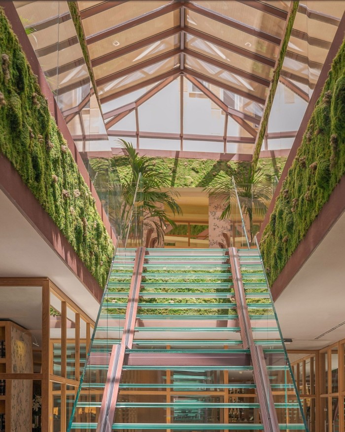 A green-glass staircase leading up to Urso’s Conservatory 