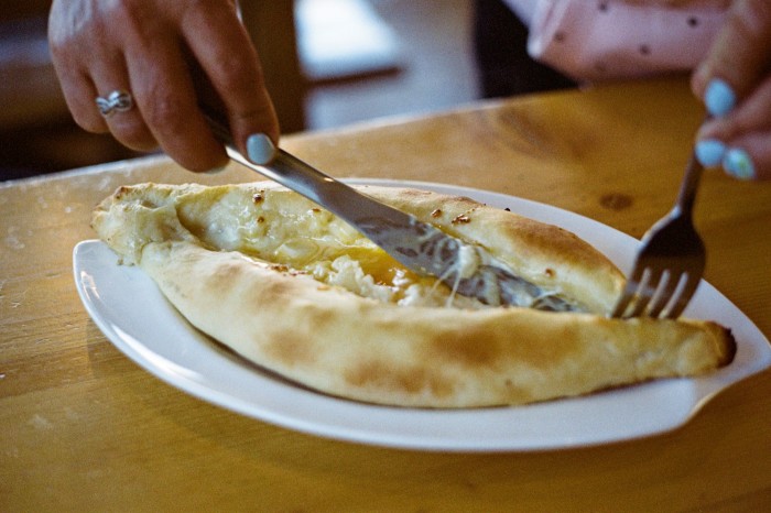 Khachapuri at Restaurant Stepantsminda. The traditional Georgian bread is filled with sulguni cheese, butter and an egg yolk, which is mixed at the table