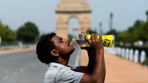 A worker quenches his thirst in New Delhi, where temperatures can sometimes approach 50 degrees Celsius