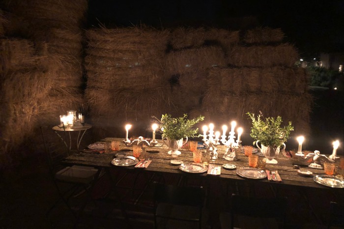 Candles and lanterns light a private dinner in the renovated barn
