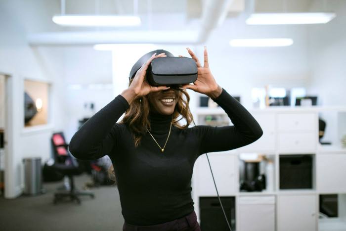 A young woman using virtual reality goggle at work 