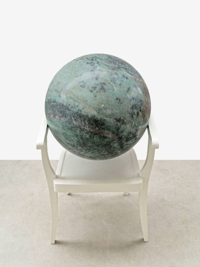 The same, except the chair is now white and the ball rests on the arms, not the seat