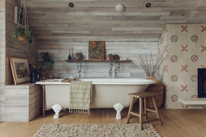 A reclaimed bath restored by Antique Baths of Ivybridge and painted in Little Greene Rolling Fog. The tiles on the chimney breast are Bert and May Deia