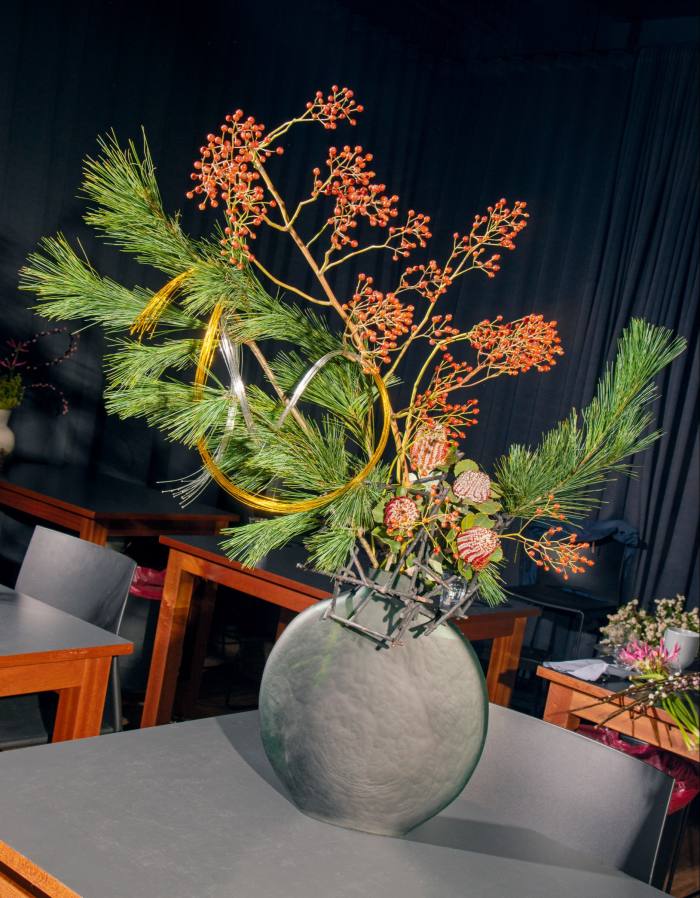 An Ikebana arrangement of pine, rosehips and banksia