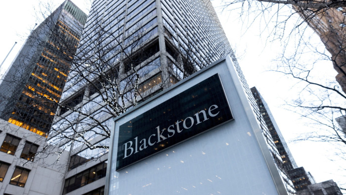 A Blackstone sign with a tower block behind it