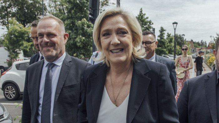 Marine Le Pen, leader of National Rally, arrives to vote at a polling station during the first round of legislative elections